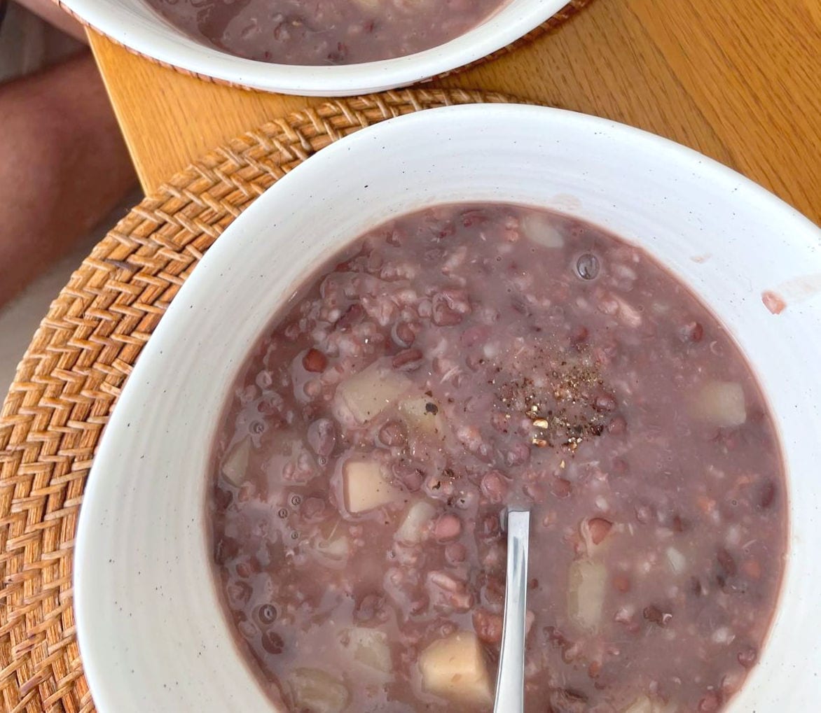 A bowl of adzuki bean porridge with taro